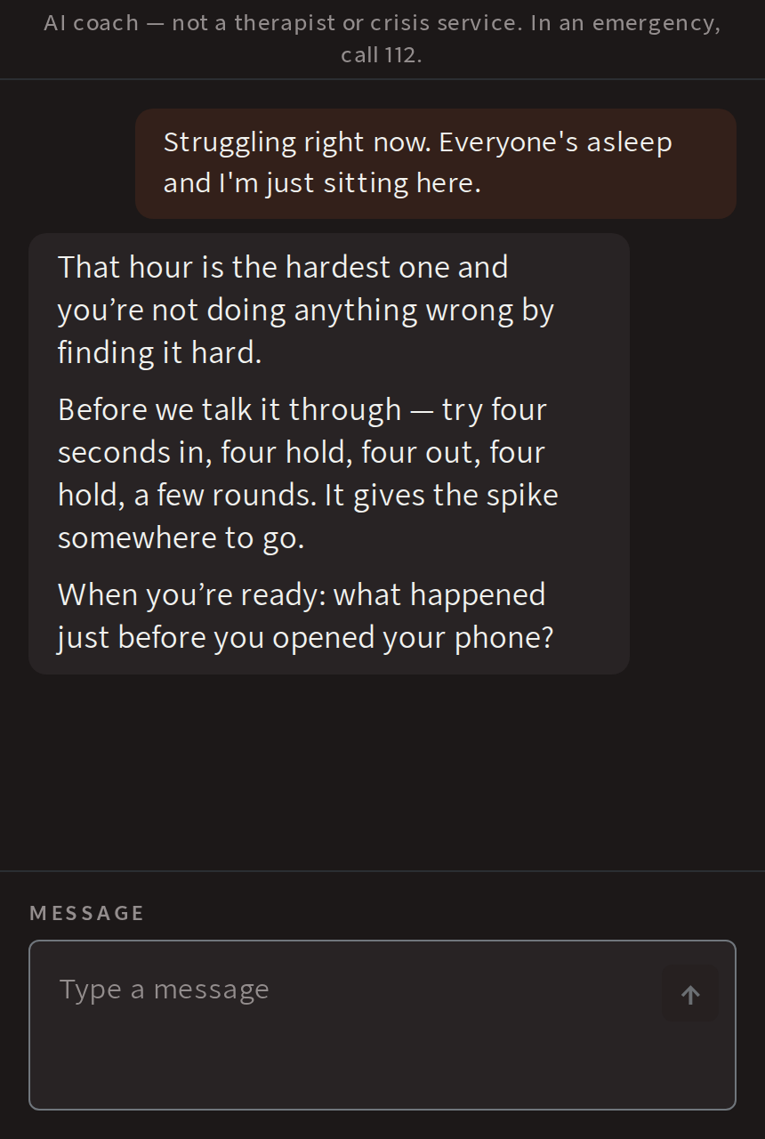 The WINNR AI coach in conversation: a man says he is struggling right now, the coach answers with a breathing step and asks what the trigger was. A line at the top reads: AI coach, not a therapist or crisis service.
