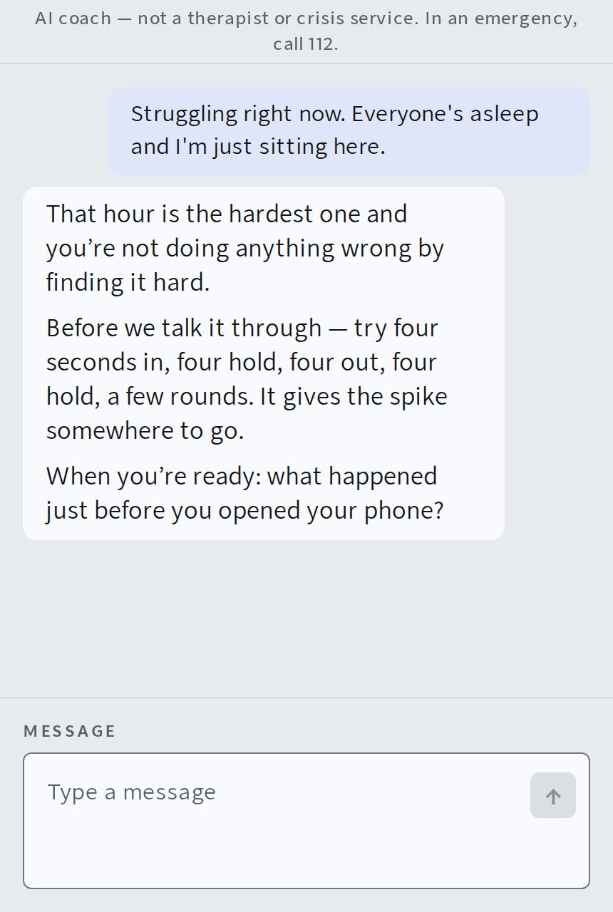 The WINNR AI coach in conversation: a man says he is struggling right now, the coach answers with a breathing step and asks what the trigger was. A line at the top reads: AI coach, not a therapist or crisis service.