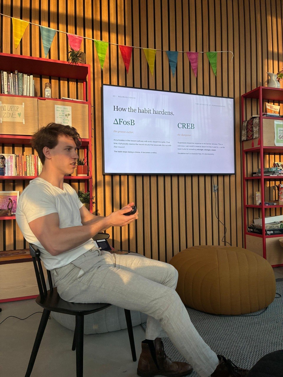 A WINNR session in progress: one of the team presenting a lesson to a room, the slide behind him reading How the habit hardens.